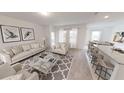 Bright living room featuring stylish decor, comfortable seating, and an open floor plan at 3251 Nightfall Rd, Winter Haven, FL 33881