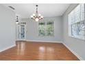 Well-lit dining room with light blue walls, wood floors, and bright windows creating a welcoming atmosphere at 3813 Goldenglow Dr, Orlando, FL 32828