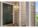 Close-up of front door showcasing unit number and inviting welcome mat at 4400 Thornbriar Ln # 104, Orlando, FL 32822