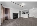 Inviting living room with a cozy fireplace, modern flooring, and neutral paint at 4400 Thornbriar Ln # 104, Orlando, FL 32822