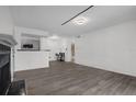 Spacious living room, view of open kitchen with stainless appliances and breakfast bar at 4400 Thornbriar Ln # 104, Orlando, FL 32822