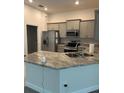 Modern kitchen featuring granite countertops, stainless steel appliances, and ample cabinet space at 4586 Se 25Th Loop, Ocala, FL 34480
