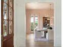 Bright dining room featuring a chandelier, light pink walls, and glass doors leading to the patio at 541 W Canton Ave, Winter Park, FL 32789