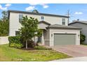 Charming two-story home features a brick driveway, neutral paint, and well-maintained landscaping at 5458 Carrara Ct, St Cloud, FL 34771