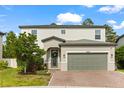 Charming two-story home with a manicured lawn, brick driveway and a two car garage at 5458 Carrara Ct, St Cloud, FL 34771