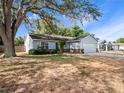 Charming single-story home features a two-car garage and well-maintained front yard at 6042 Brookhill Cir, Orlando, FL 32810