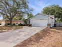 Charming single-story home features a two-car garage and long driveway at 6042 Brookhill Cir, Orlando, FL 32810
