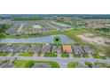 Community aerial showcasing neighborhood layout, lush greenery, and scenic lakes at 636 San Augusto Dr, Kissimmee, FL 34759