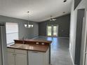 Open-concept living room featuring modern gray paint, lots of natural light, and tile flooring throughout at 6625 Cherry Grove Cir, Orlando, FL 32809