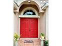 Inviting front entrance featuring a vibrant red double door with an arched window at 6704 Westlake Blvd, Orlando, FL 32810