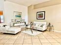 Elegant living room with neutral tones, tile flooring and contemporary furniture at 6704 Westlake Blvd, Orlando, FL 32810