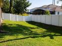 Well-maintained backyard with a privacy fence and lush green grass, perfect for outdoor activities at 6728 Duncaster St, Windermere, FL 34786