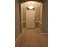 Bright entryway featuring neutral wall paint, decorative trim and neutral tile flooring at 6728 Duncaster St, Windermere, FL 34786