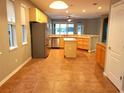 Open-concept kitchen featuring stainless steel appliances, a breakfast bar and a center island at 6728 Duncaster St, Windermere, FL 34786