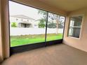 View from the covered patio looking out to the backyard with a white fence at 6728 Duncaster St, Windermere, FL 34786