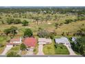 An aerial view of property with a golf course in the background at 721 Fairway Dr, New Smyrna Beach, FL 32168
