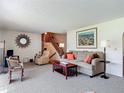 Inviting living room featuring plush carpet, wood accents, and ample seating at 721 Fairway Dr, New Smyrna Beach, FL 32168