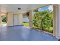 Covered carport area leading to the home's side entrance, offering protection from the elements at 10856 William Tell Dr, Orlando, FL 32821