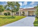 Inviting home with a well-maintained lawn, cozy front patio set, and a convenient attached carport at 10856 William Tell Dr, Orlando, FL 32821