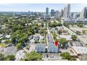 Aerial view of townhomes in a walkable area, with the downtown city skyline in the distance at 117 E Concord St # 7, Orlando, FL 32801