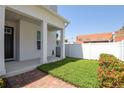 Quaint front yard featuring manicured lawn space, brick pavers, and a covered porch at 117 E Concord St # 7, Orlando, FL 32801