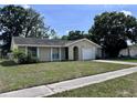 Cozy single-story home with attached one car garage, and driveway at 117 N Alderwood St, Winter Springs, FL 32708
