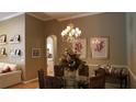 Cozy dining room with modern chandelier, seating for six, and decorative wall art at 13016 Islamorada Dr, Orlando, FL 32837