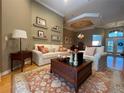 Inviting living room featuring a decorative ceiling, comfortable furniture, and a stylish area rug at 13016 Islamorada Dr, Orlando, FL 32837