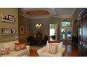 Inviting living room featuring hardwood floors, a tray ceiling, and lots of natural light at 13016 Islamorada Dr, Orlando, FL 32837