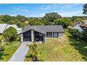 Attractive single-story home with a well-maintained yard and a sleek black and white exterior design at 17 S Flag Ct, Kissimmee, FL 34759