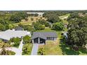 Single-story home with a sleek black and white exterior nestled among lush greenery at 17 S Flag Ct, Kissimmee, FL 34759