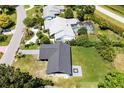 Well-maintained single-story home features a dark roof, contrasted by a spacious, green yard at 17 S Flag Ct, Kissimmee, FL 34759