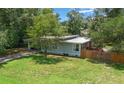 Well-kept home with a lush green lawn, fenced yard, and mature landscaping at 1881 Cottonwood St, Orange City, FL 32763
