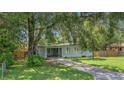 Attractive home featuring a neatly manicured lawn, driveway, and mature shade trees at 1881 Cottonwood St, Orange City, FL 32763
