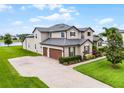 Spacious home boasts a three-car garage and expansive driveway, perfect for Gathering and guests at 2260 Grayling St, Orlando, FL 32820