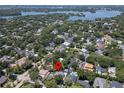 Aerial view of a neighborhood showcasing tree-lined streets and proximity to a lake and parks at 2339 Lafayette Ave, Winter Park, FL 32789