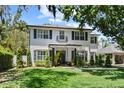 Charming two-story home featuring a well-manicured lawn, landscaping, and a quaint porch at 2339 Lafayette Ave, Winter Park, FL 32789