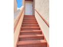 Exterior stairway leading to unit's door with sturdy red handrails and neutral exterior paint at 2468 Citrus Club Ln # 502, Orlando, FL 32839