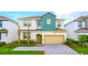 Charming two-story home featuring a well-manicured lawn, two palm trees, and a welcoming entrance at 266 Marcello Blvd, Kissimmee, FL 34746