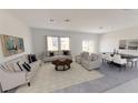 Bright living room featuring contemporary furnishings, neutral tones, and ample natural light at 3041 Daffodil Dr, Lake Hamilton, FL 33851