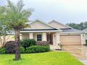 Charming single-story home featuring a well-manicured lawn and a two-car garage at 305 Grande Lake Dr, Daytona Beach, FL 32124