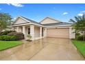 Charming single-story home featuring a well-manicured lawn and a two-car garage at 305 Grande Lake Dr, Daytona Beach, FL 32124