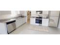 Modern kitchen with stainless steel appliances, granite countertops, and ample cabinet space at 3079 Sunset Hills Rd, Winter Haven, FL 33881