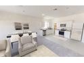 Open-concept living space featuring modern furnishings and a seamless flow to the kitchen at 3079 Sunset Hills Rd, Winter Haven, FL 33881