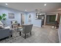 Inviting living room with tile flooring, neutral paint, and an open concept design to the kitchen at 3300 Needles Dr, Orlando, FL 32810