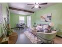 Cozy living room featuring neutral tones, beamed ceilings, modern decor, and ample natural light at 3300 Needles Dr, Orlando, FL 32810