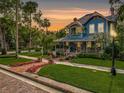 Charming two-story home with a spacious porch, manicured lawn and mature trees at 420 S Oak Ave, Sanford, FL 32771