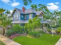 Charming two-story home with lush landscaping, mature trees and manicured lawn at 420 S Oak Ave, Sanford, FL 32771