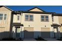 This townhome boasts a well-manicured lawn and attached garage at 639 Longboat Dr, Davenport, FL 33896
