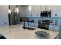 Modern kitchen with stainless steel appliances, ample storage, and a large island at 639 Longboat Dr, Davenport, FL 33896